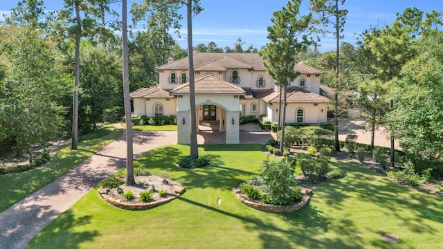 mediterranean / spanish-style home featuring a front lawn