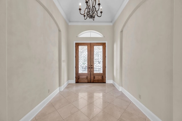 entrance foyer featuring french doors, ornamental molding, an inviting chandelier, and light tile patterned flooring