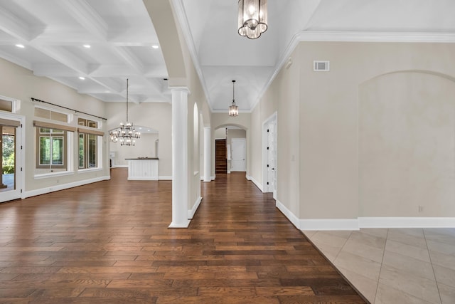 foyer with beam ceiling, ornamental molding, coffered ceiling, decorative columns, and a chandelier