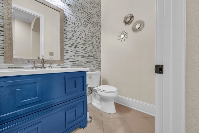 bathroom with decorative backsplash, tile patterned floors, toilet, and vanity