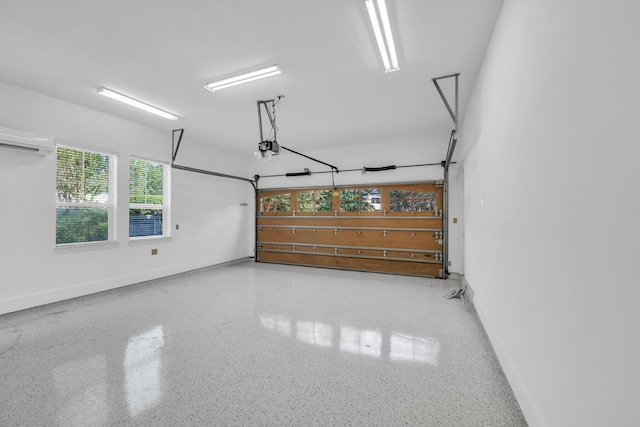 garage featuring a garage door opener and a wall mounted air conditioner