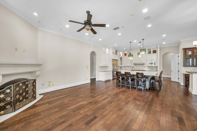 dining room with wine cooler, ceiling fan, crown molding, and dark hardwood / wood-style floors