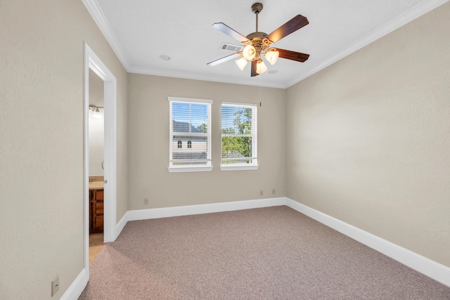 carpeted empty room with ceiling fan and crown molding