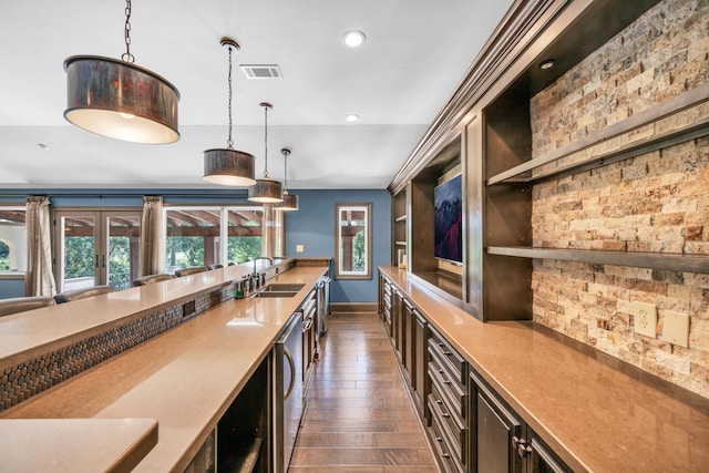 bar with sink, decorative light fixtures, built in shelves, and dark hardwood / wood-style flooring