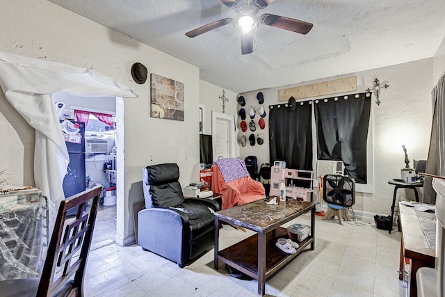 living room featuring ceiling fan, cooling unit, and a textured ceiling