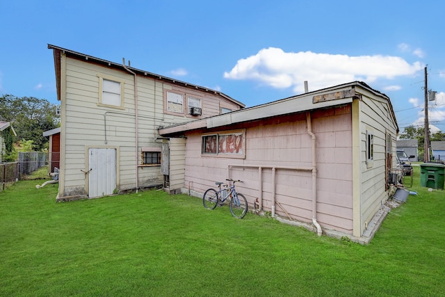 back of house with a lawn