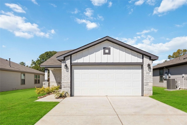 view of front of property featuring a garage, central air condition unit, and a front yard