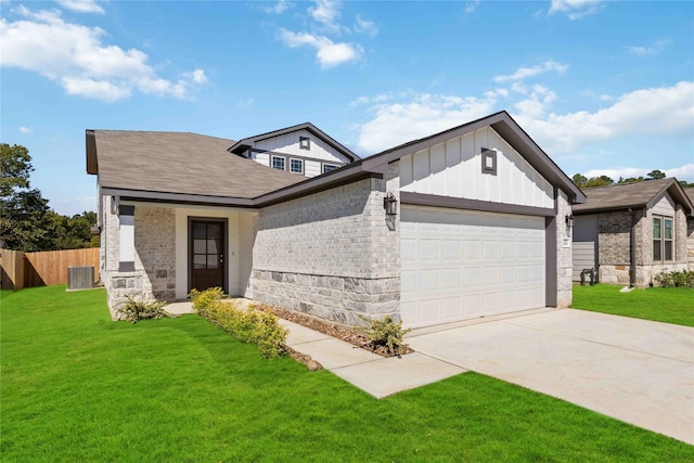 view of front of home featuring a garage, cooling unit, and a front lawn