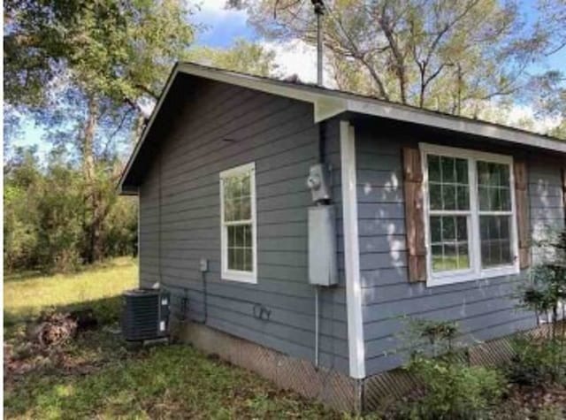 view of side of property with central air condition unit