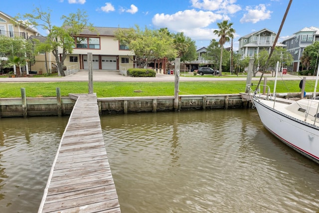 dock area featuring a yard and a water view