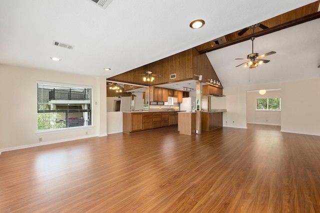 unfurnished living room with a healthy amount of sunlight and hardwood / wood-style floors