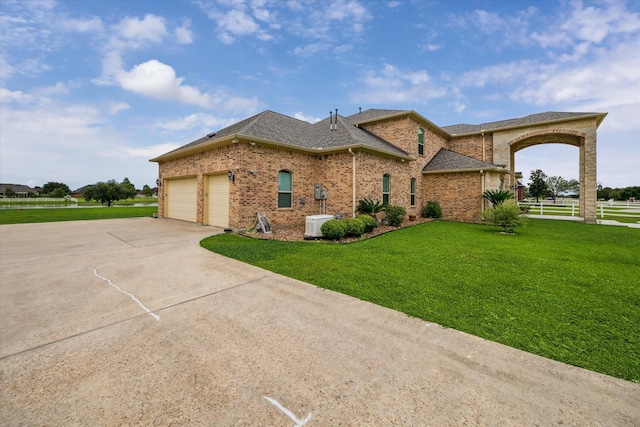 view of front of property with a garage and a front yard