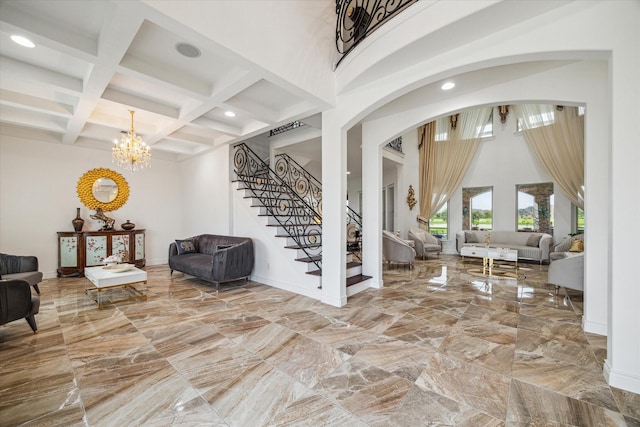 foyer featuring a notable chandelier, beamed ceiling, and coffered ceiling