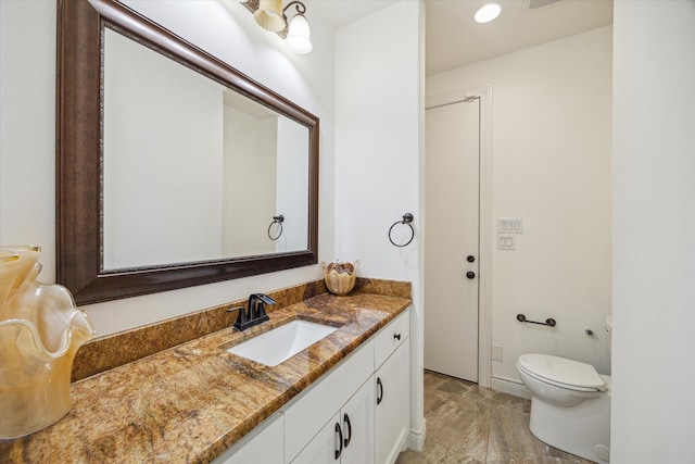 bathroom with toilet and vanity