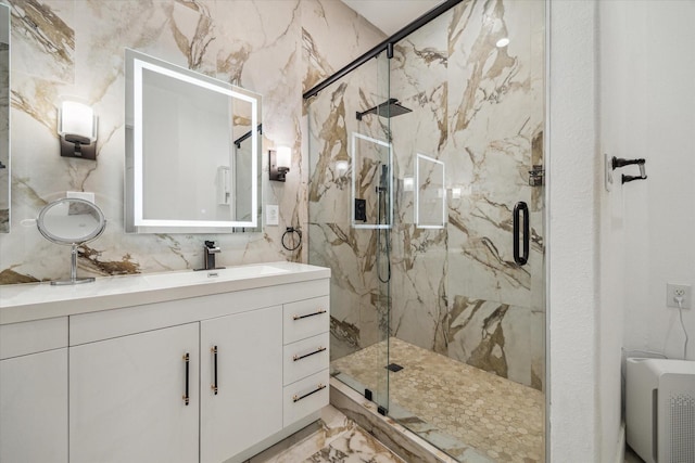 bathroom with vanity and a shower with shower door