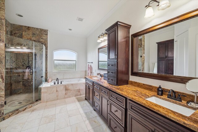 bathroom featuring independent shower and bath, ornamental molding, and vanity