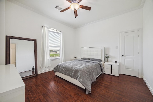 bedroom featuring crown molding, dark hardwood / wood-style floors, and ceiling fan