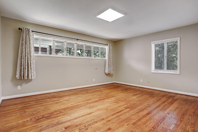 spare room featuring light hardwood / wood-style flooring