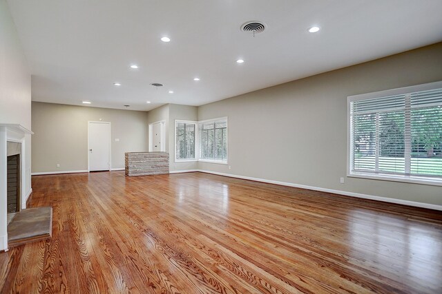 unfurnished living room featuring light hardwood / wood-style floors and plenty of natural light