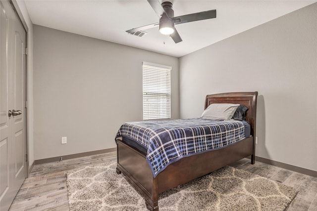 bedroom with a closet, ceiling fan, and light wood-type flooring