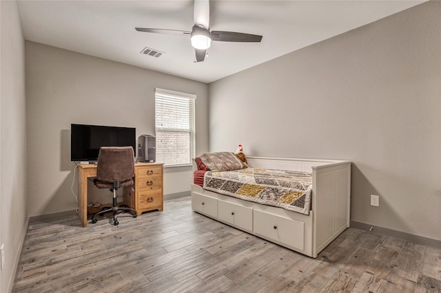 bedroom with light hardwood / wood-style flooring and ceiling fan