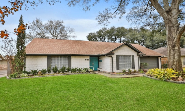 single story home featuring a garage and a front lawn