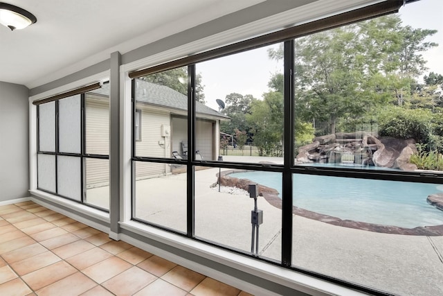 doorway to outside featuring a wealth of natural light and light tile patterned floors