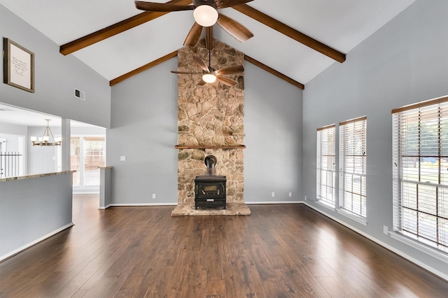 unfurnished living room featuring high vaulted ceiling, a wood stove, dark hardwood / wood-style flooring, and beamed ceiling