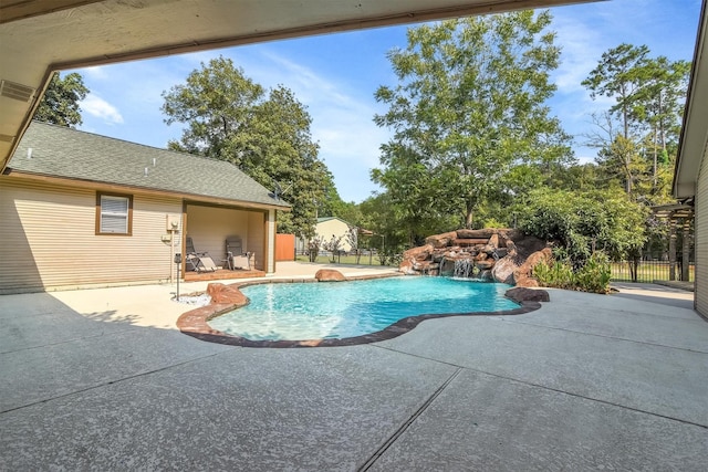 view of pool with a patio and pool water feature