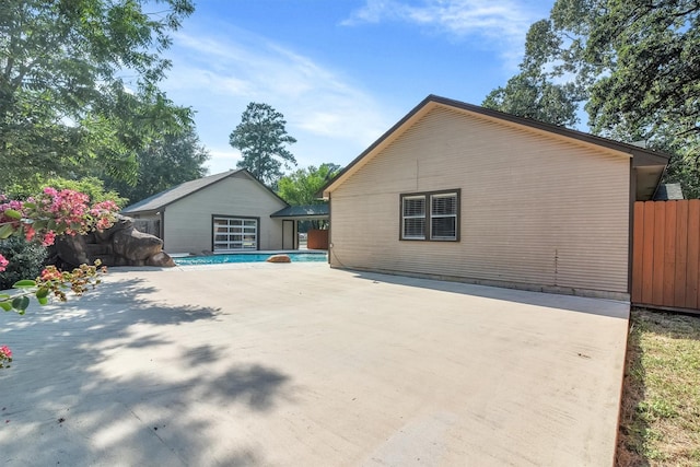 view of side of property with a patio