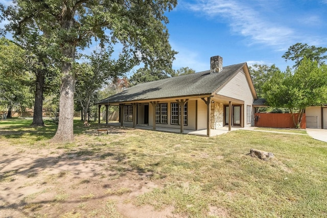 back of house featuring a patio area and a yard