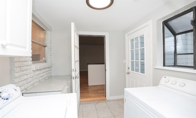 laundry room featuring light tile patterned floors and cabinets