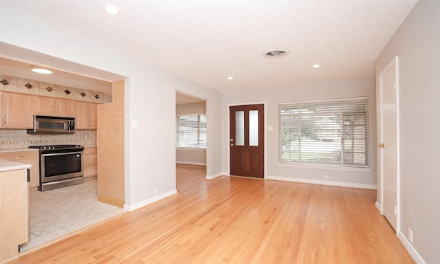 entryway with light hardwood / wood-style floors