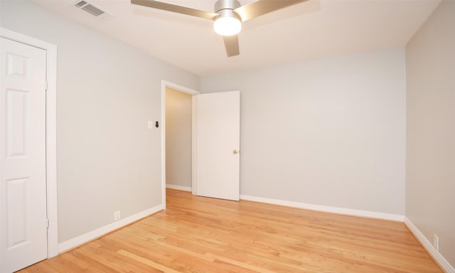 spare room featuring ceiling fan and light hardwood / wood-style flooring