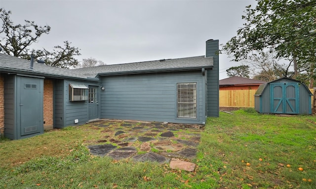 rear view of house featuring a shed and a yard