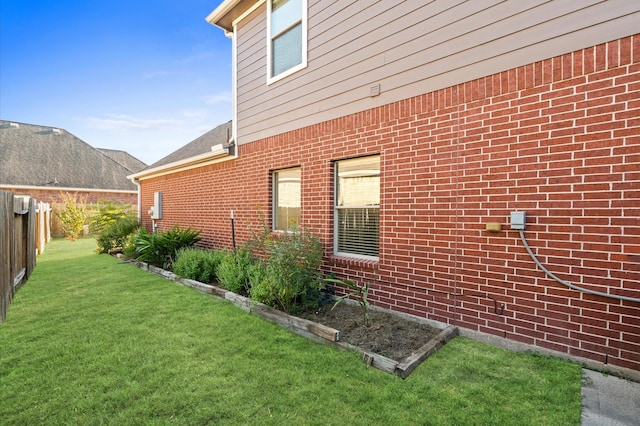 view of side of home featuring a lawn