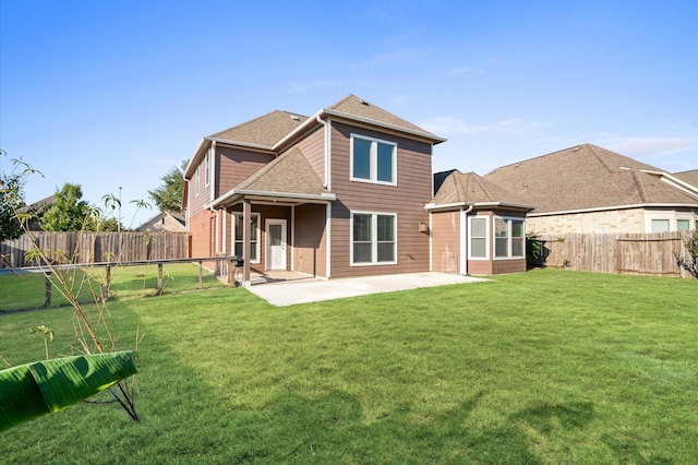 back of house featuring a patio area and a lawn