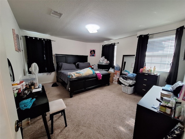 carpeted bedroom with a textured ceiling