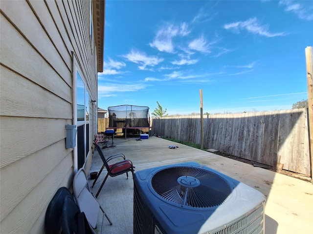 view of patio / terrace with central AC unit and a trampoline