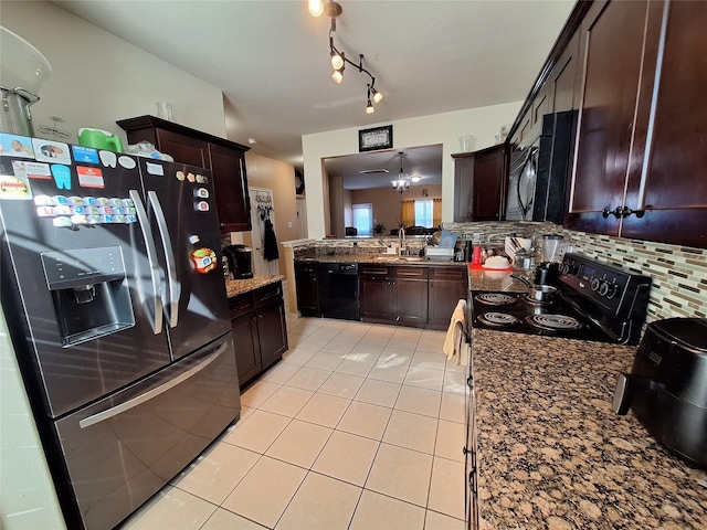 kitchen with light tile patterned flooring, black appliances, decorative backsplash, and dark brown cabinets