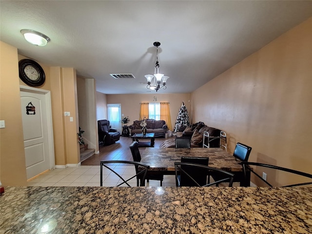 kitchen featuring light tile patterned floors and a notable chandelier