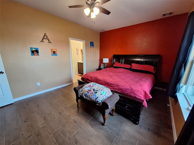 bedroom featuring hardwood / wood-style floors, connected bathroom, and ceiling fan