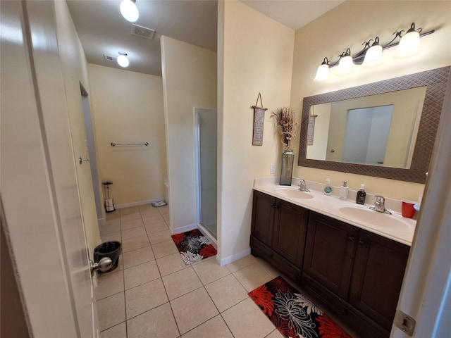 bathroom with tile patterned floors, vanity, and an enclosed shower