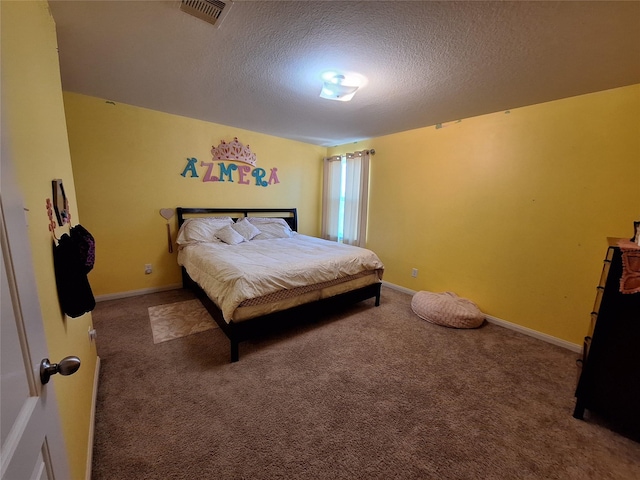 carpeted bedroom featuring a textured ceiling