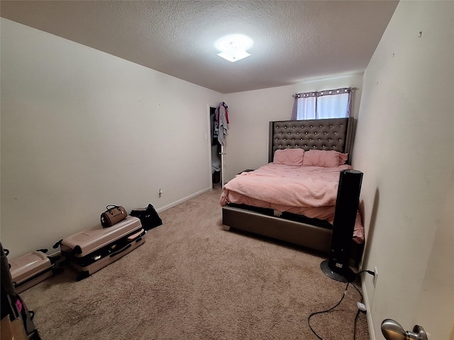 bedroom with a textured ceiling and carpet flooring