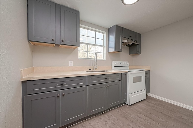 kitchen featuring light hardwood / wood-style floors, sink, gray cabinetry, and white electric range