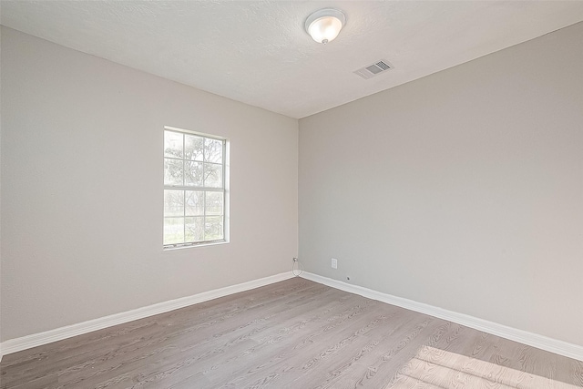 unfurnished room featuring light hardwood / wood-style floors