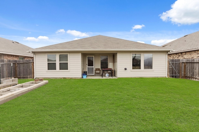 back of house featuring a patio area and a yard