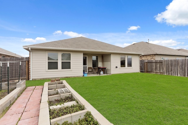 rear view of property featuring a patio and a yard