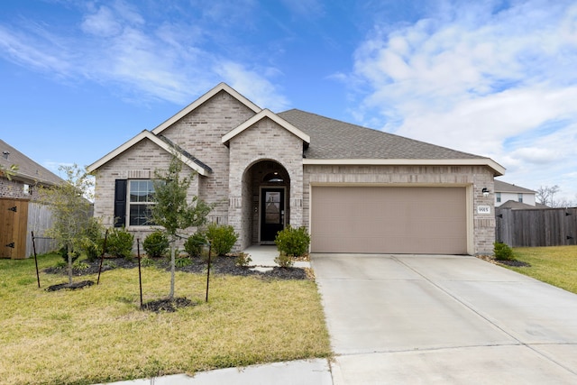 view of front of home featuring a garage and a front lawn